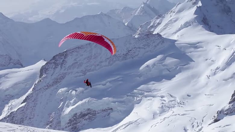 Backdrop from Ueli Steck - Paraglides Between Mountains In The Swiss Alps